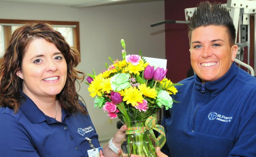 Amber DaGama Rose, PT, Rehab Department Facilitator presents flowers to Jessica Ball
