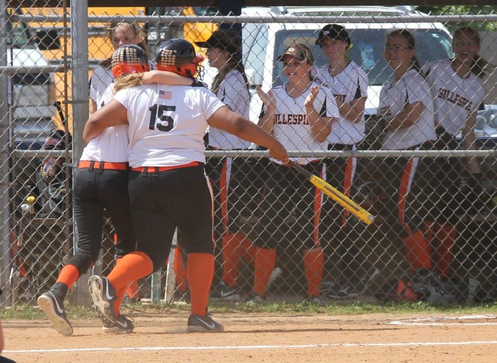 Mackenzie Kasarda (left) hugs Lizzy Nance (right, #15) after Nance's hit allowed Mackenzie to score. 