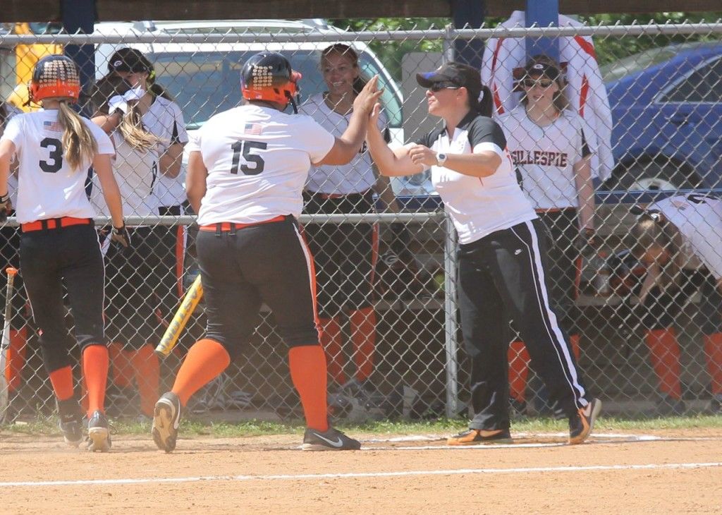Head coach Michelle Smith congratulates Lizzy Nance on her hit in yesterday's regional championship victory. 