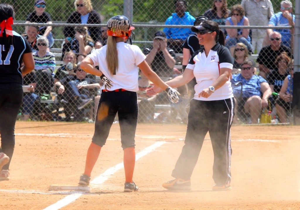 Head coach Michelle Smith congratulates Addy Bryant on her triple. 