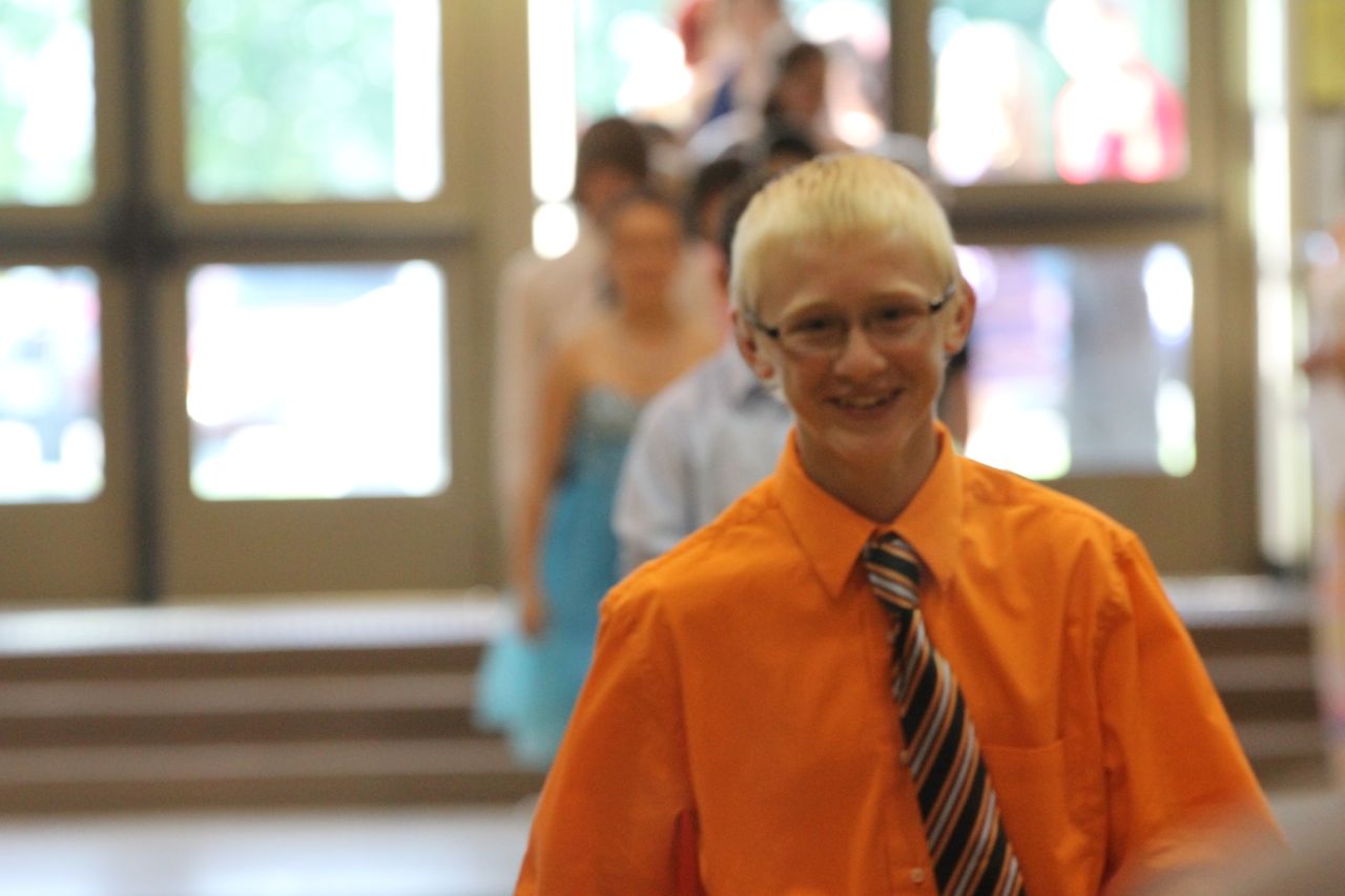 Joey Carter flashes a smile during his entrance into the promotion ceremony. 