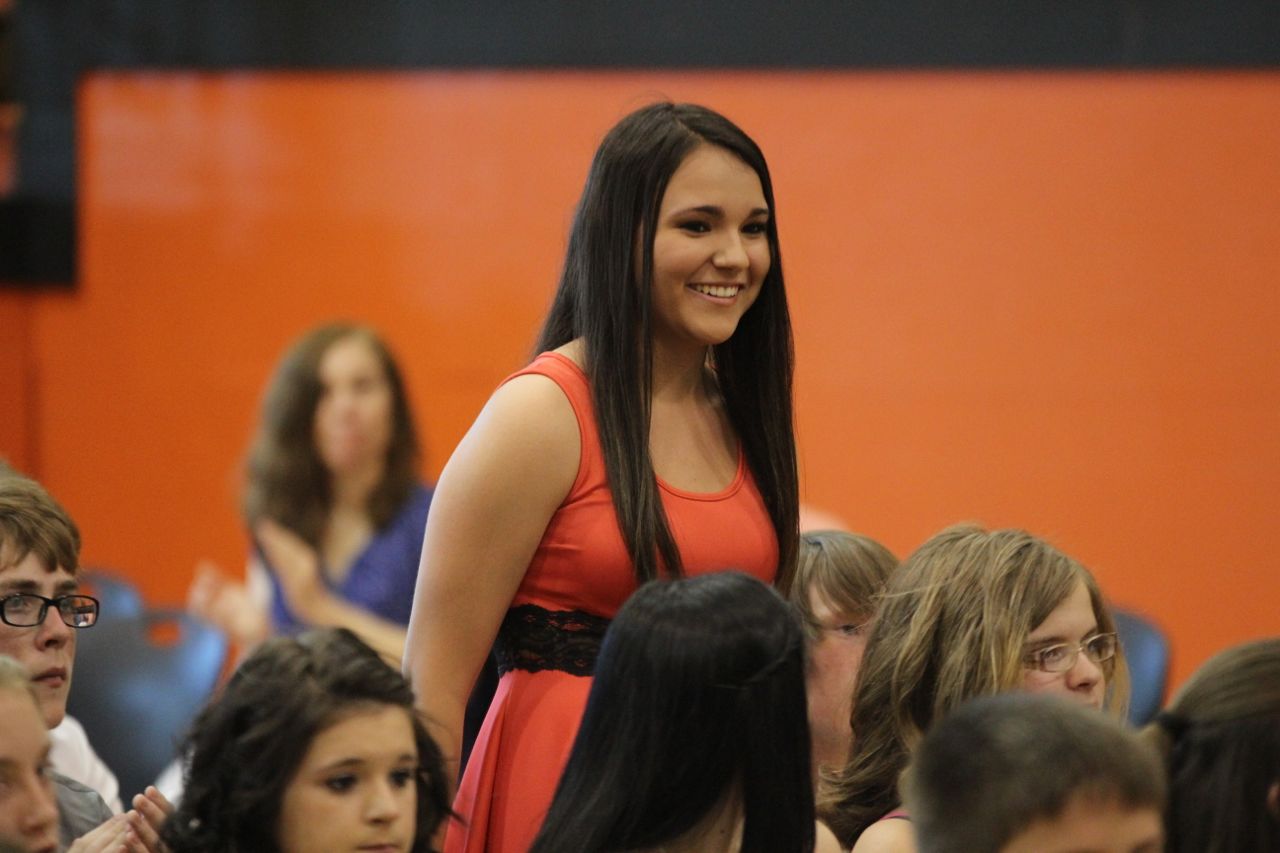 Juliann Hendricks stands and smiles after being honored for an award. 