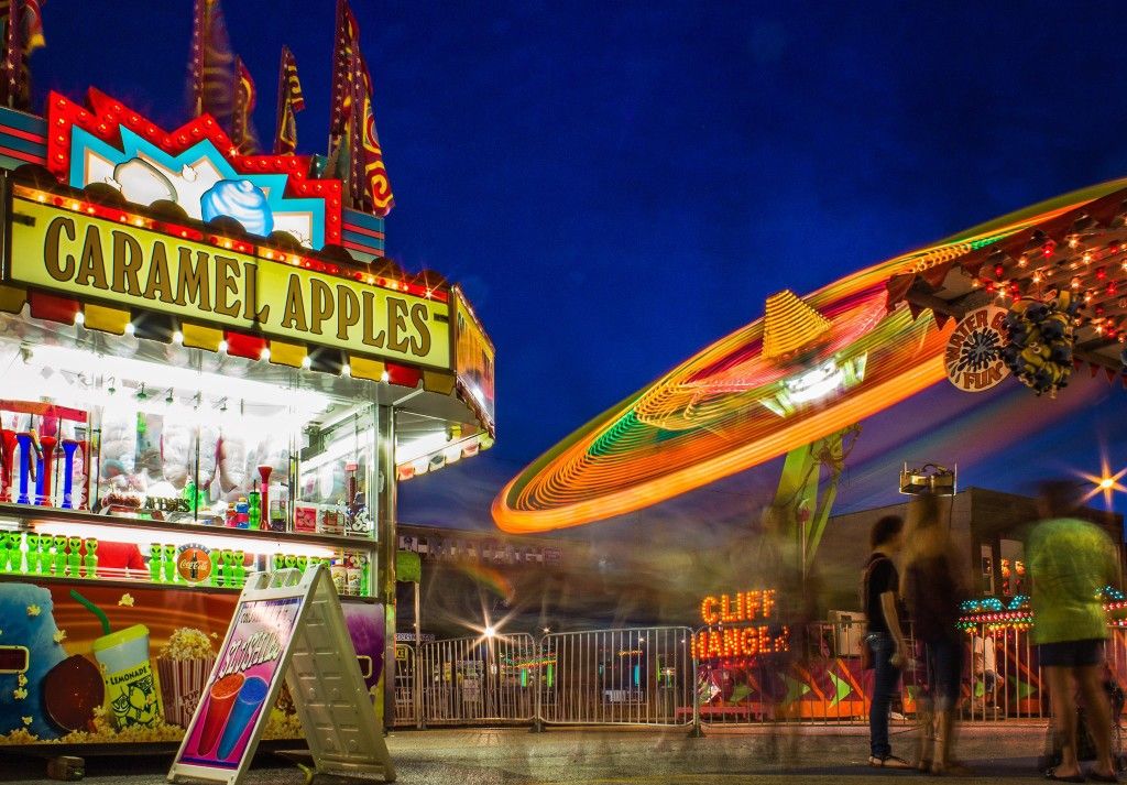 An image of the caramel apple concession stand and the cliff hanger ride in the background. (Photo by Angelia Fenton)