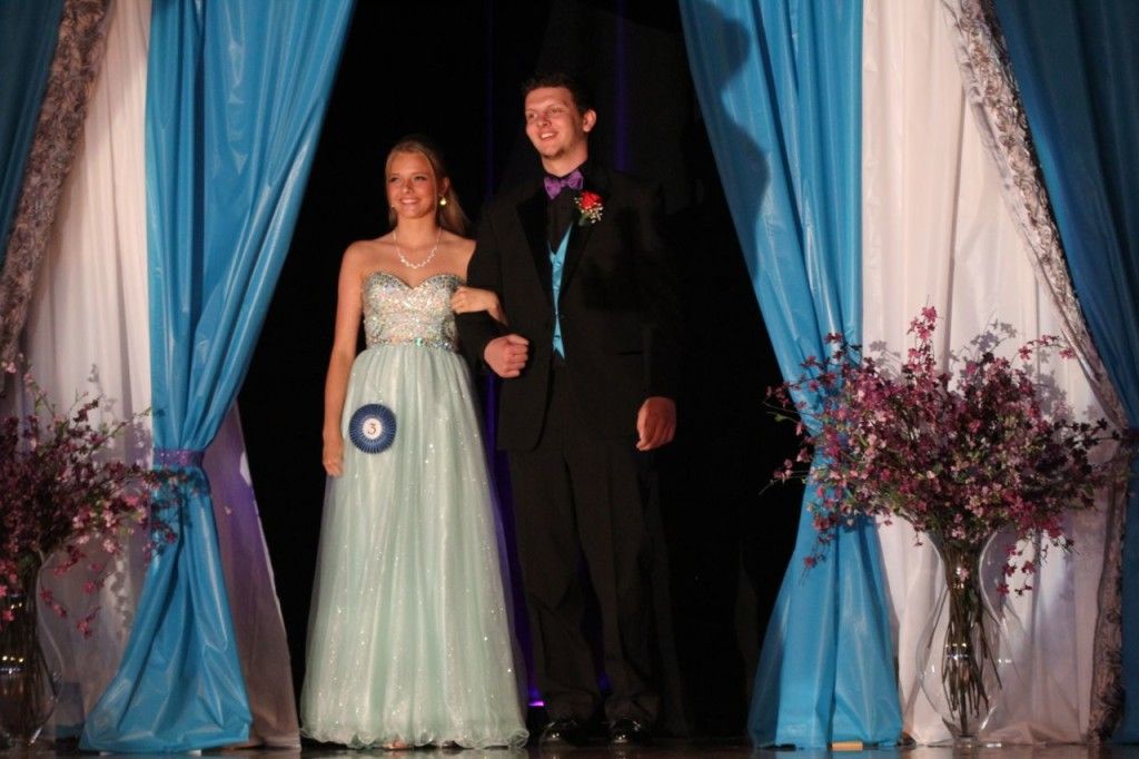 Nate Henrichs (right) escorts Kirsten Sherman to the stage in her evening gown outfit. 