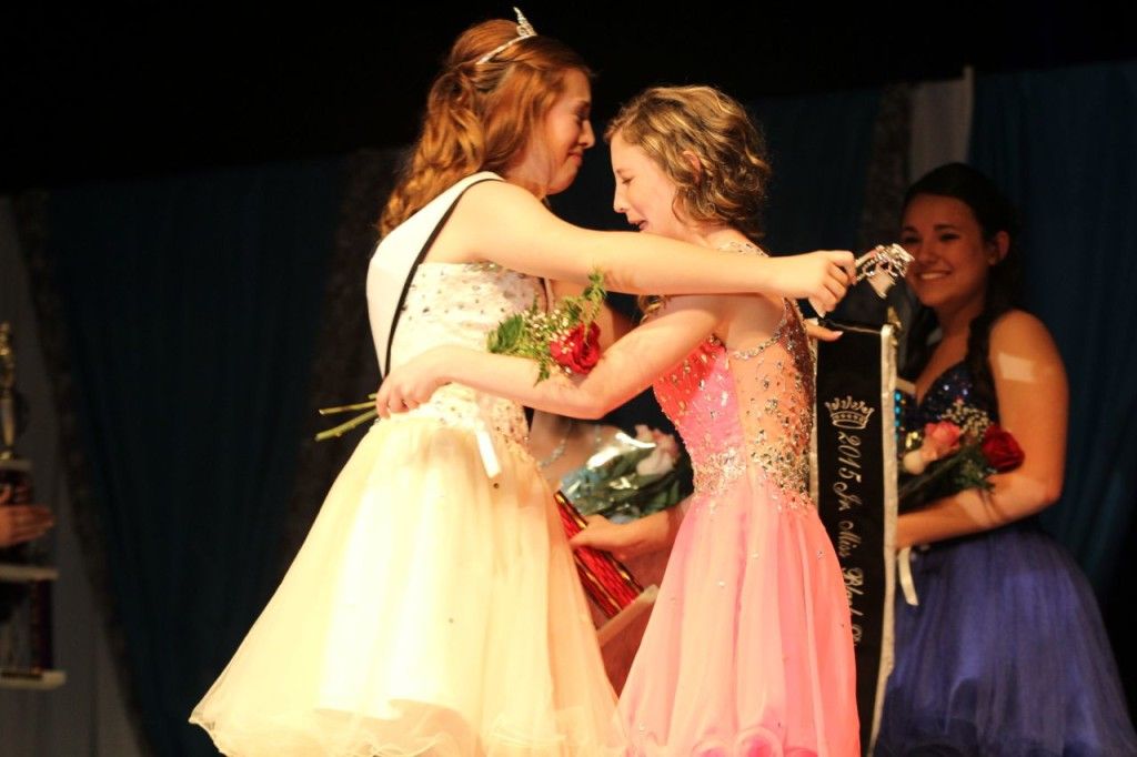 Madison Hedrick (right) hugs Grace Martin, 2014 junior miss, after being announced as 2015 Black Diamond Days Jr. Miss. 