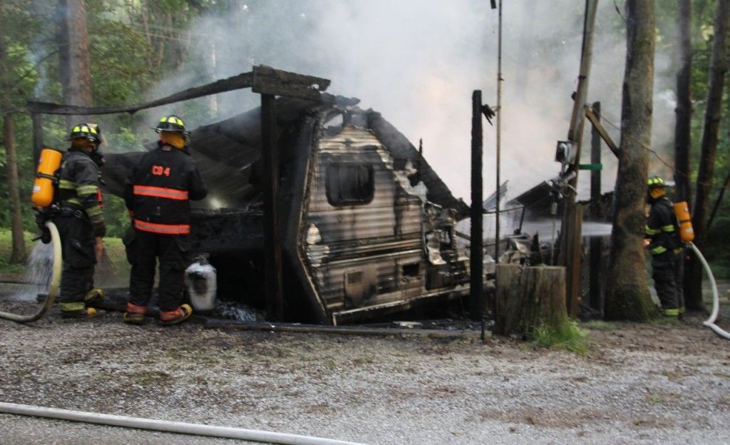 Fire fighters from Gillespie Fire Department extinguish the camper fire. 