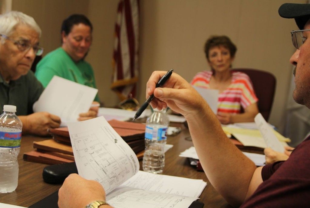 Members of the Benld City Council review the preliminary plans for the post office.