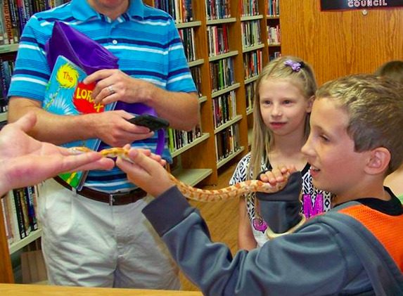 Youngsters who attended Benld Library's program last week learned how to handle and hold harmless snakes. 