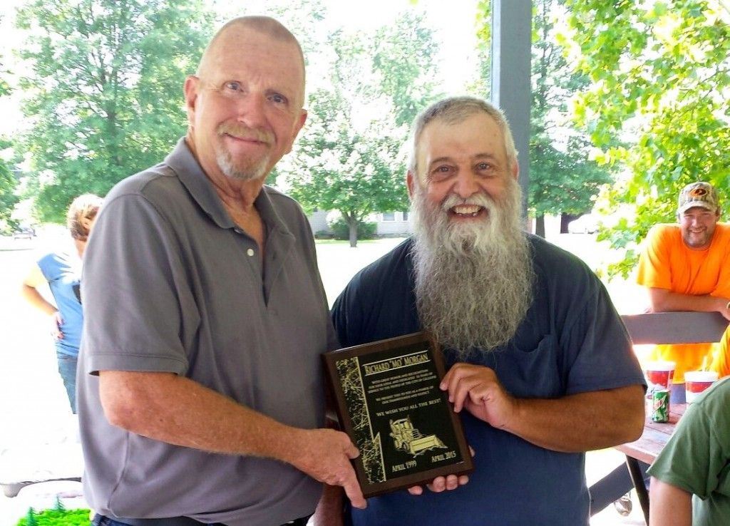 Gillespie Mayor John Hicks presents Moe Morgan with an appreciation plaque at Morgan's retirement party held at Big Brick Park in Gillespie. Morgan worked for the City of Gillespie's maintenance department for 16 years after starting in 1999 and retiring in April of 2015. (Photo by Janice Weidner)