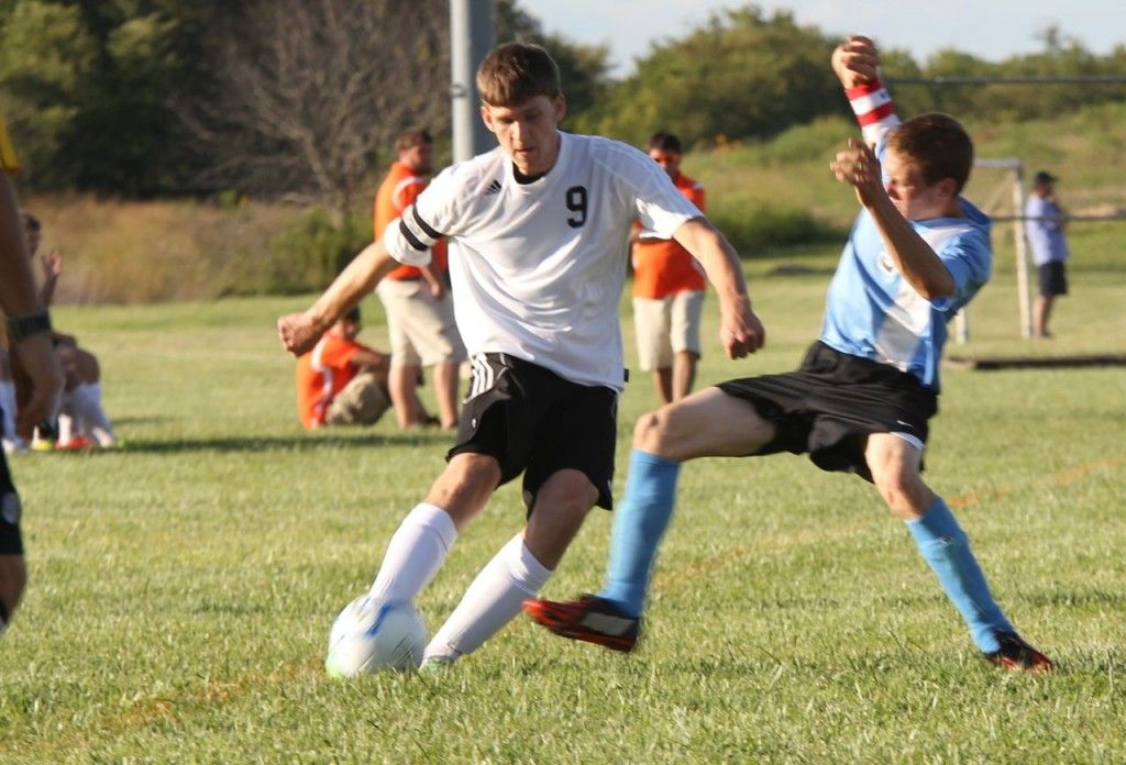 Blake Hayes fends off a North Mac defender as he brings the ball down the field for Gillespie. 