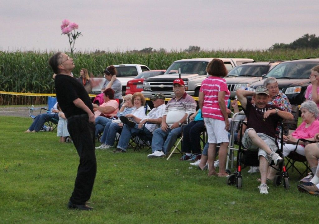 A magician entertains the crowd by balancing silk flowers on his nose during Mt. Clare's 100th anniversary celebration. Read more about the celebration. 