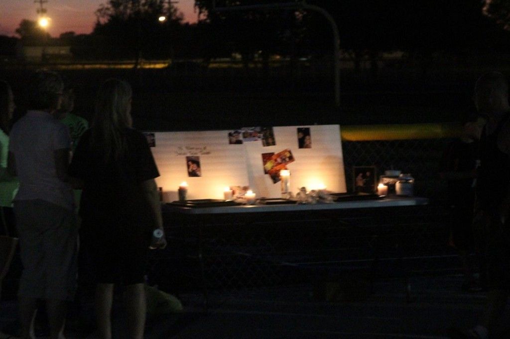 Poster boards with sincere messages and pictures of Jacob Savant sit on a table with candles at the candle vigil held Wednesday evening for the passed 18-year-old. 