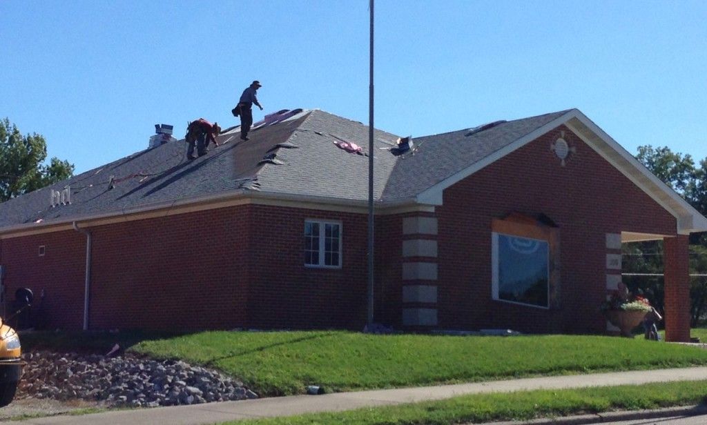 Roofers replace the roof on the Benld Public Library last week after the library received an rural development grant for the project. 