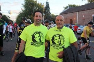 The family of Joseph Magnani stands in front of the bicyclists this morning before the mass start.