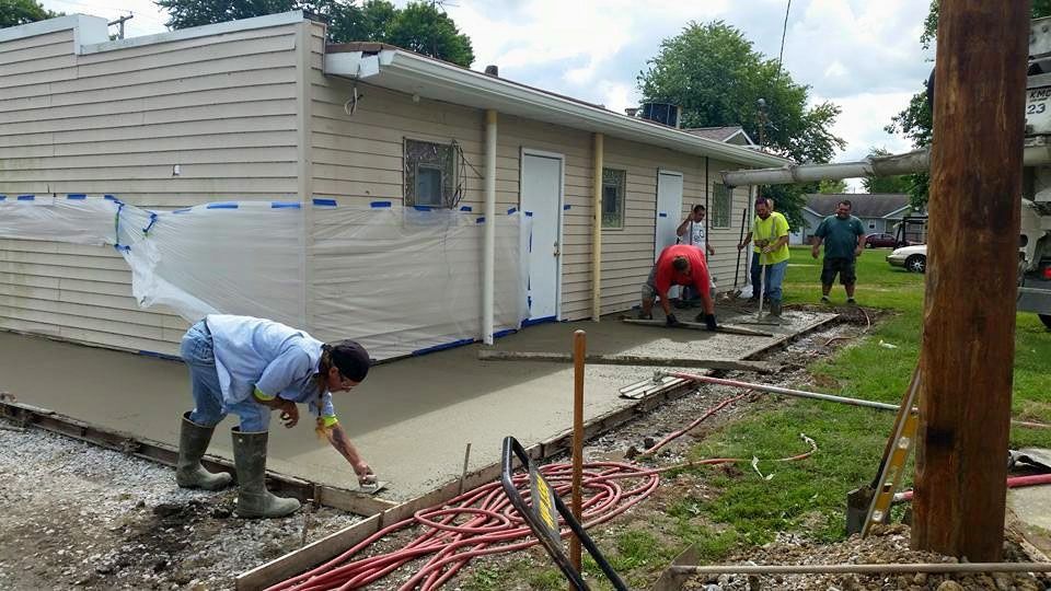 Wilsonville citizens and volunteers teamed up to complete the concrete work at the village's community center. The village is installing a handicap entrance made available by a grant received. (Photo by the Village of Wilsonville)