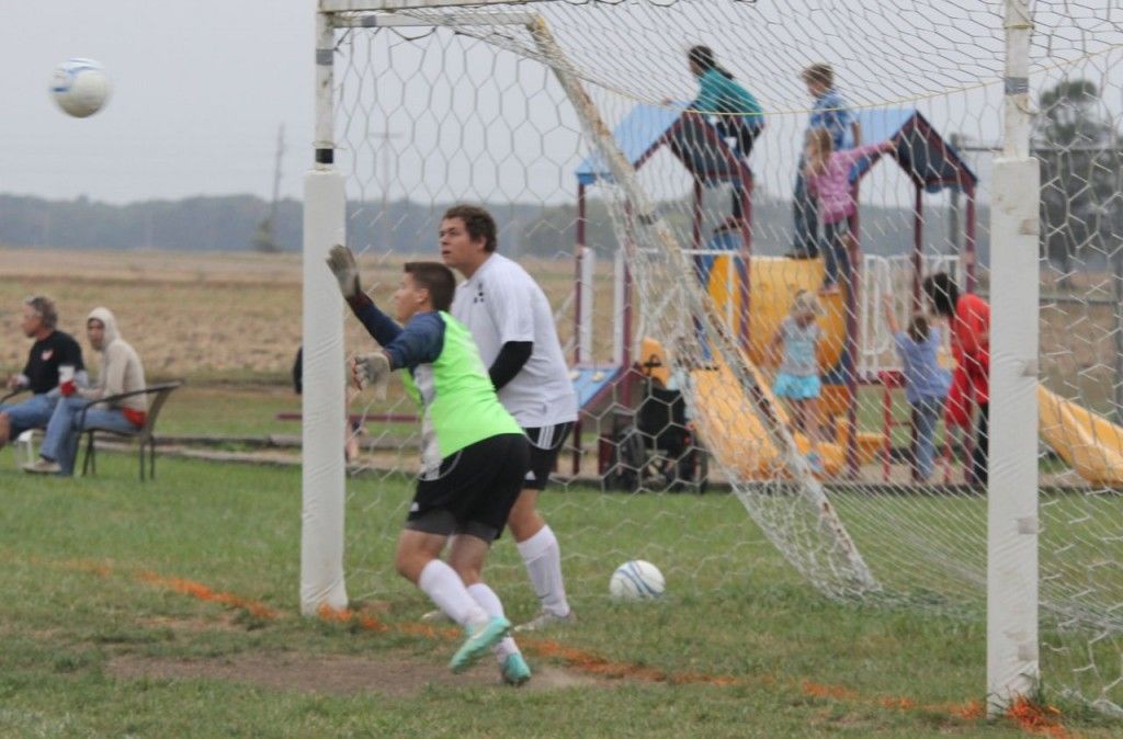 Dylan Roberts (green shirt) plays goalie for Gillespie and blocks a shot on goal. 