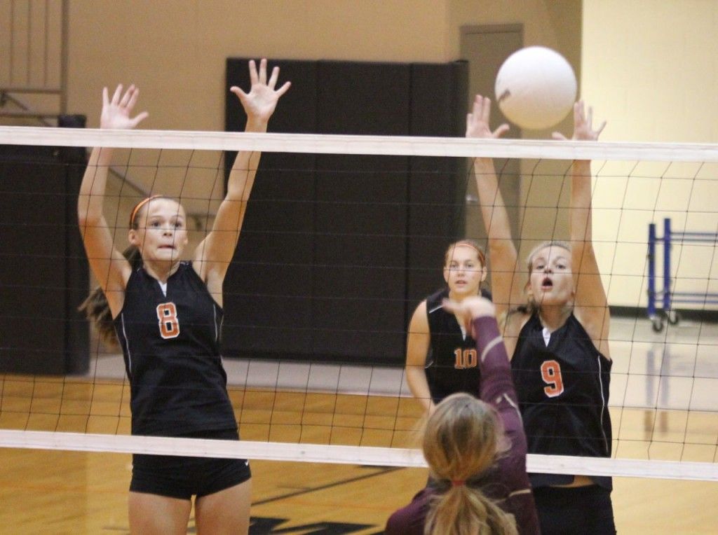 Bailey Jarman (left) and Mackenzie Kasarda (right) go up for the block in Gillespie's loss to East-Alton Wood River last week. 