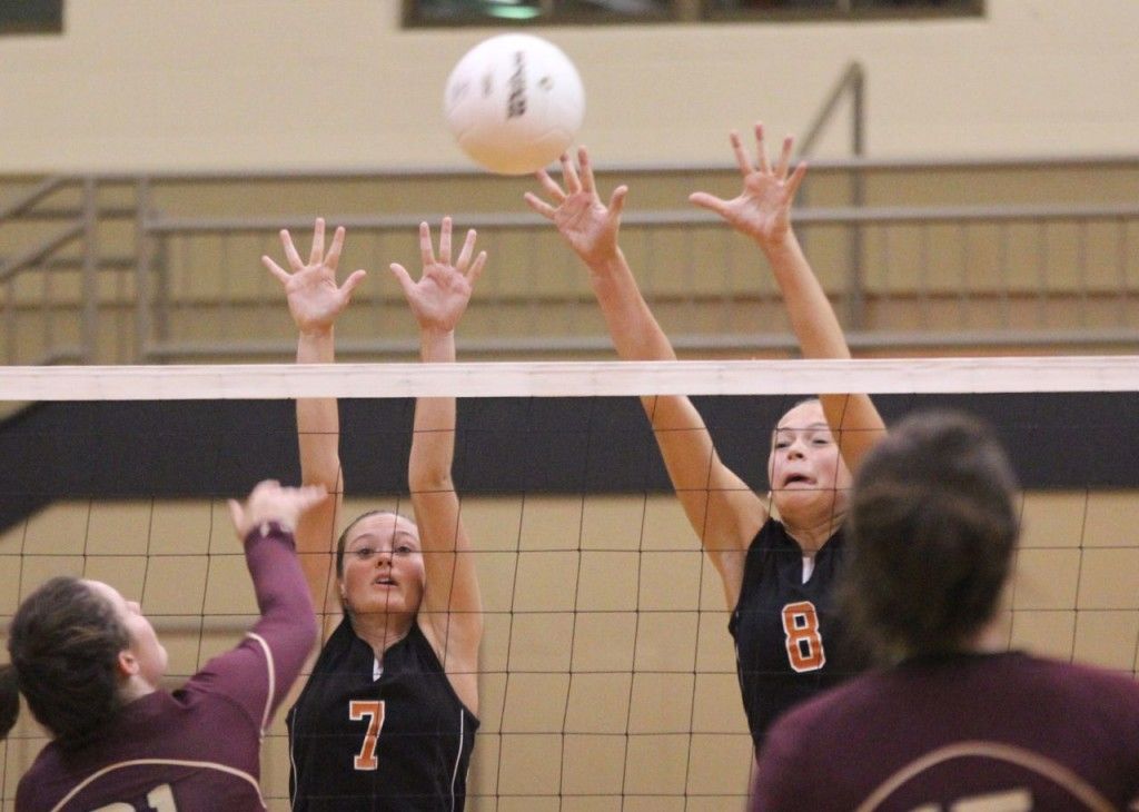 Abby Eccles (left) and Bailey Jarman (right) attempt to block a bump over the net. 