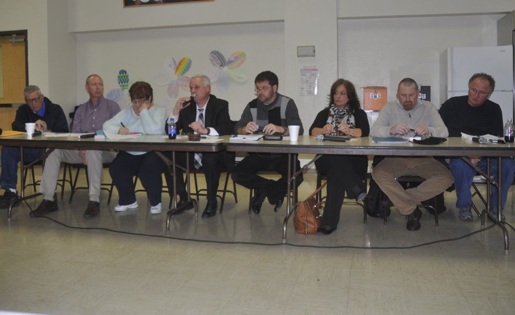 The school board sitting before the faculty and staff.