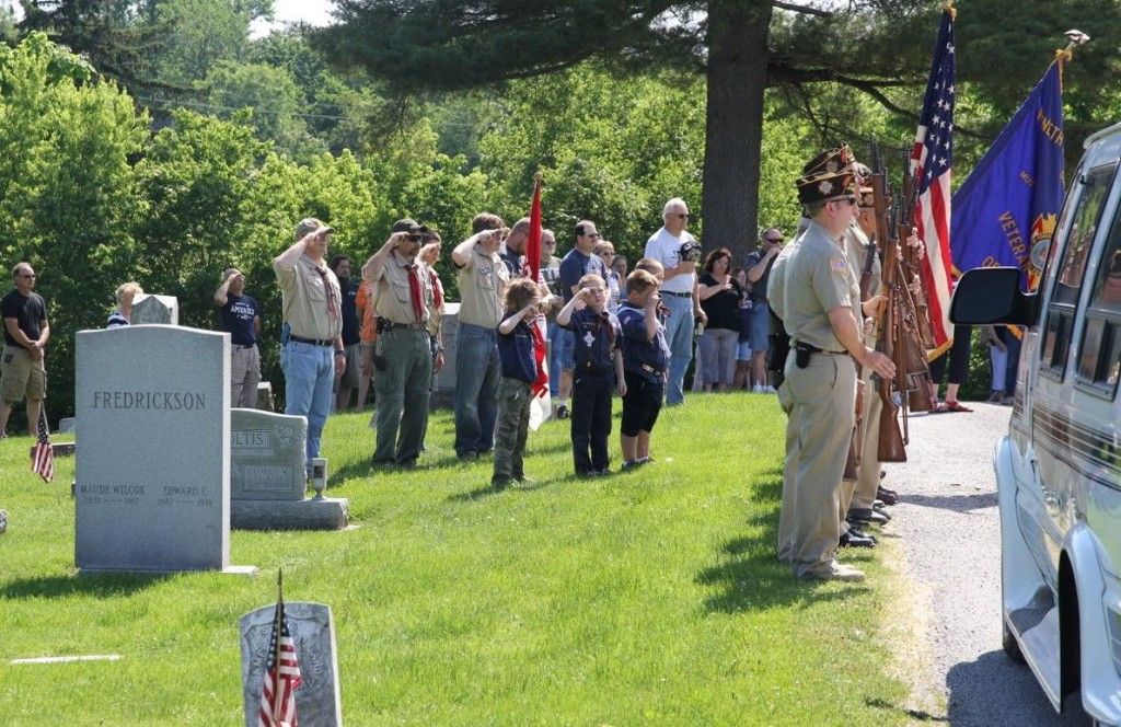 Gillespie VFW Post 4547 and Boy Scout Troop 51 salute the American flag during taps. 