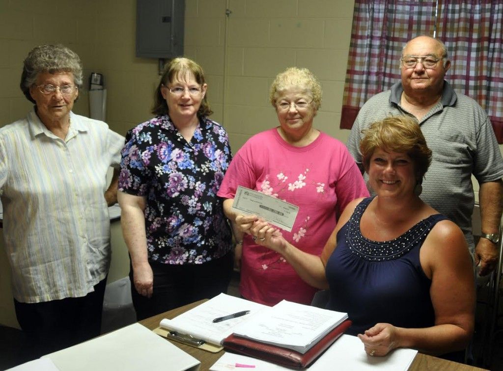 Betty Vanucci, Jan Mohr, Rosalee Schuey and Keith Mohr, representing the Wilsonville Thursday Seniors group, present a check for $1,700 to Wilsonville Village President Annetta Veres during Tuesday night’s meeting of the Wilsonville Board of Trustees. The group raised the money through a spaghetti dinner and directed that half of the donation be earmarked for the purchase of a generator for the Wilsonville Community Center.