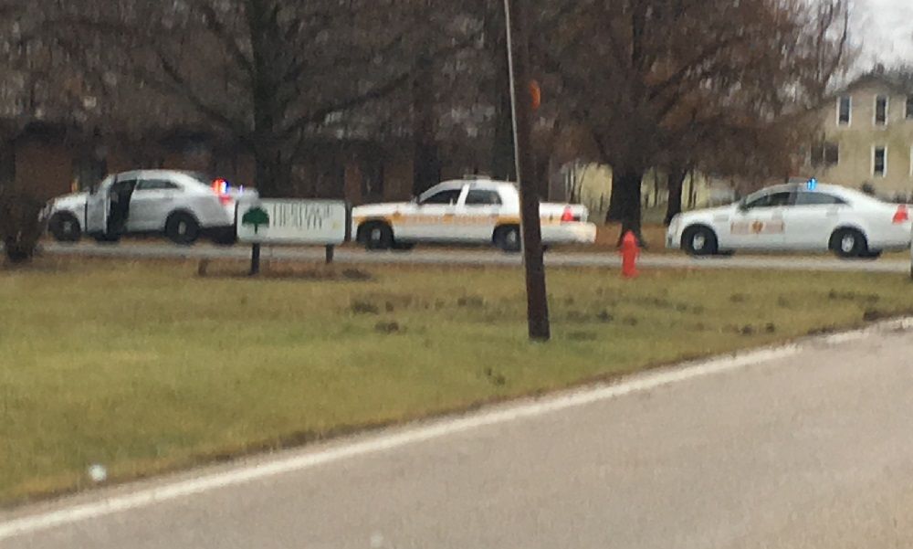 Police vehicles are parked in the entrance of Heritage Health of Gillespie as they finish the report at the scene of the accident. 