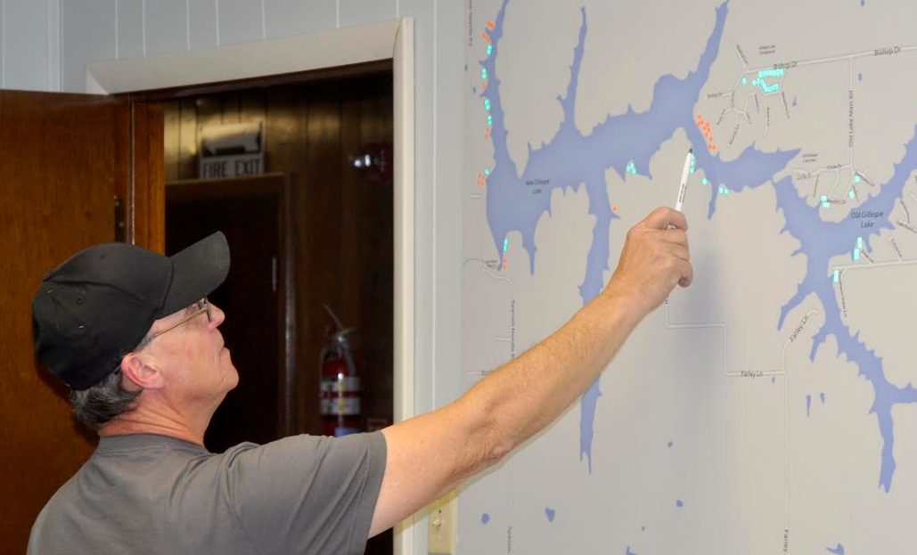 Alderman Frank Barrett points to the location of the newly approved lake lots signified by orange dots.